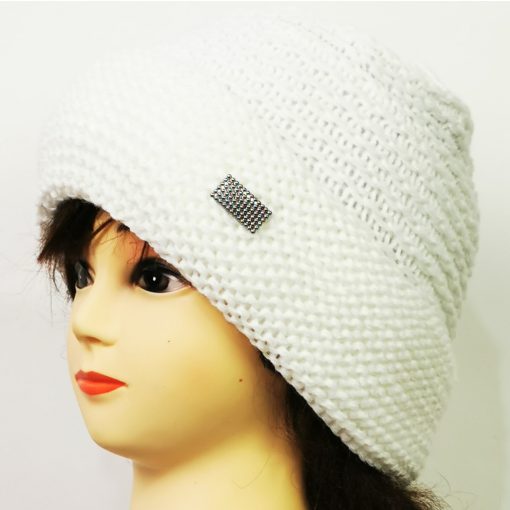 Gépi kötött, dupla anyagú,fehér színü  anyagában mintás, díszített sapka